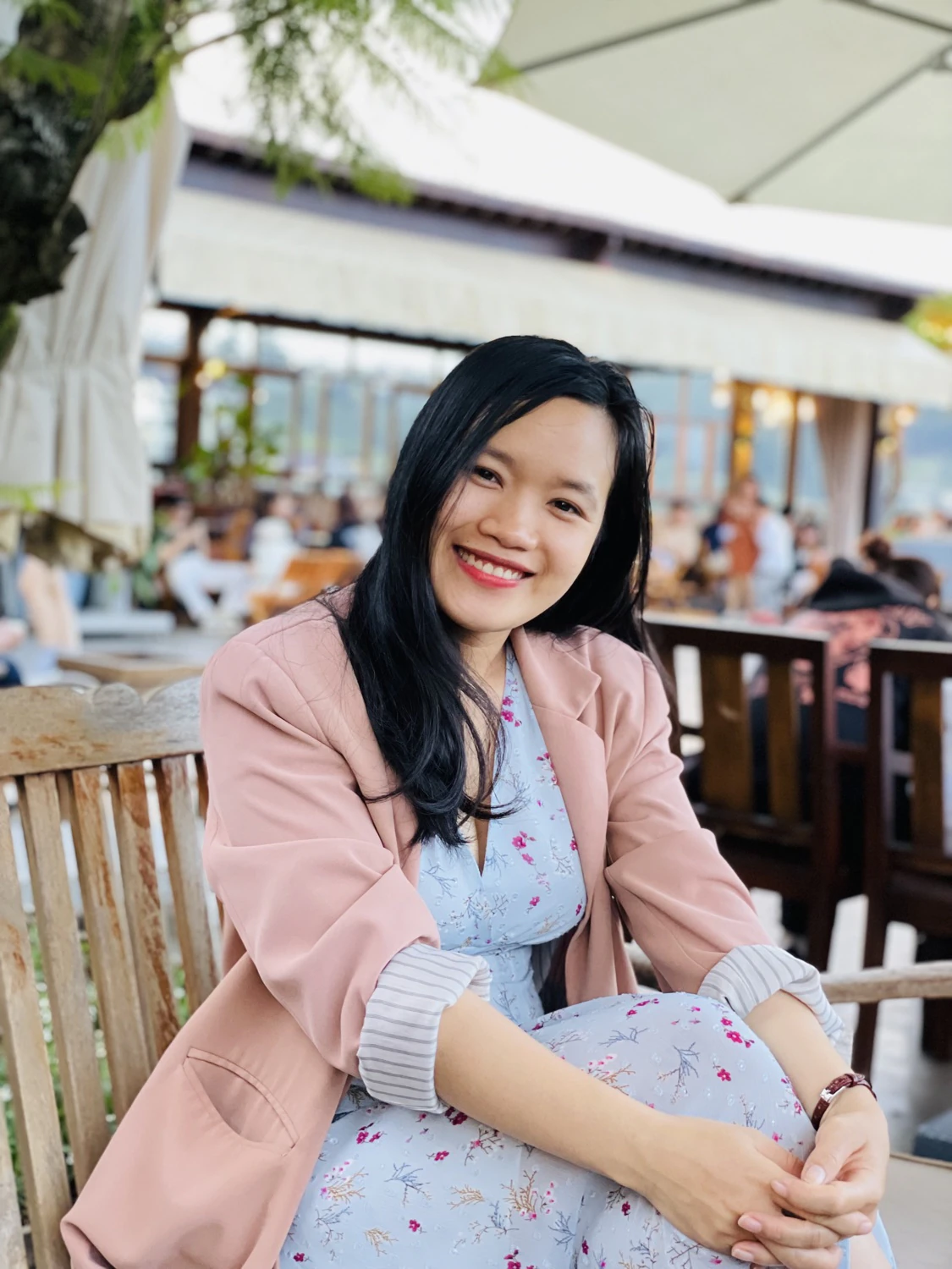 Portrait of Ly Nguyen smiling at a café