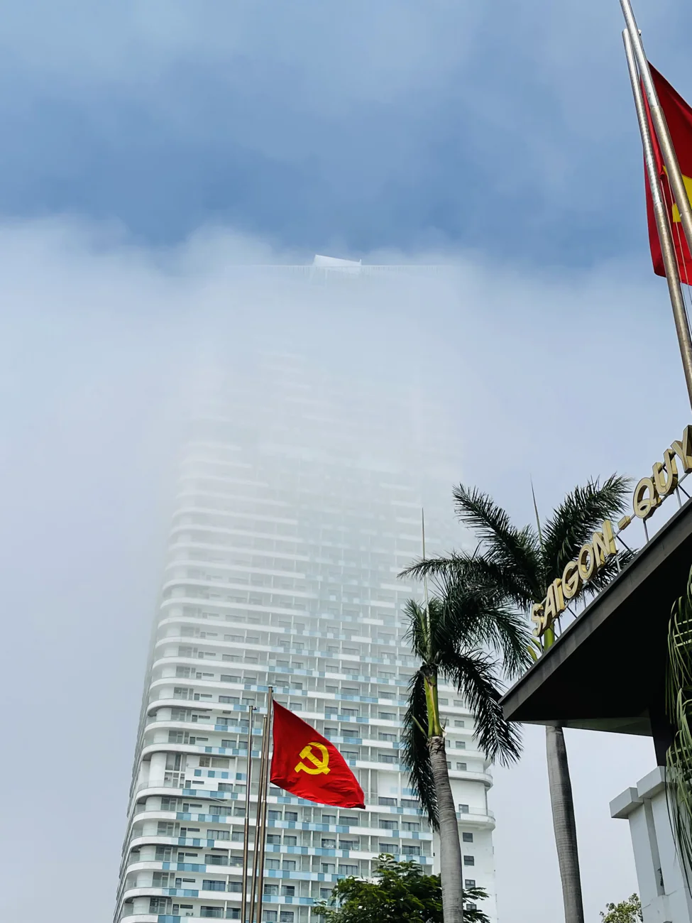 A seaside tower in Quy Nhon half-hidden in morning sea mist